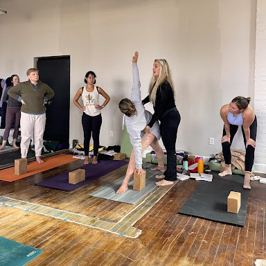 Leslee Tzrcinski teaching students yoga alignment and posture - Tune Yoga